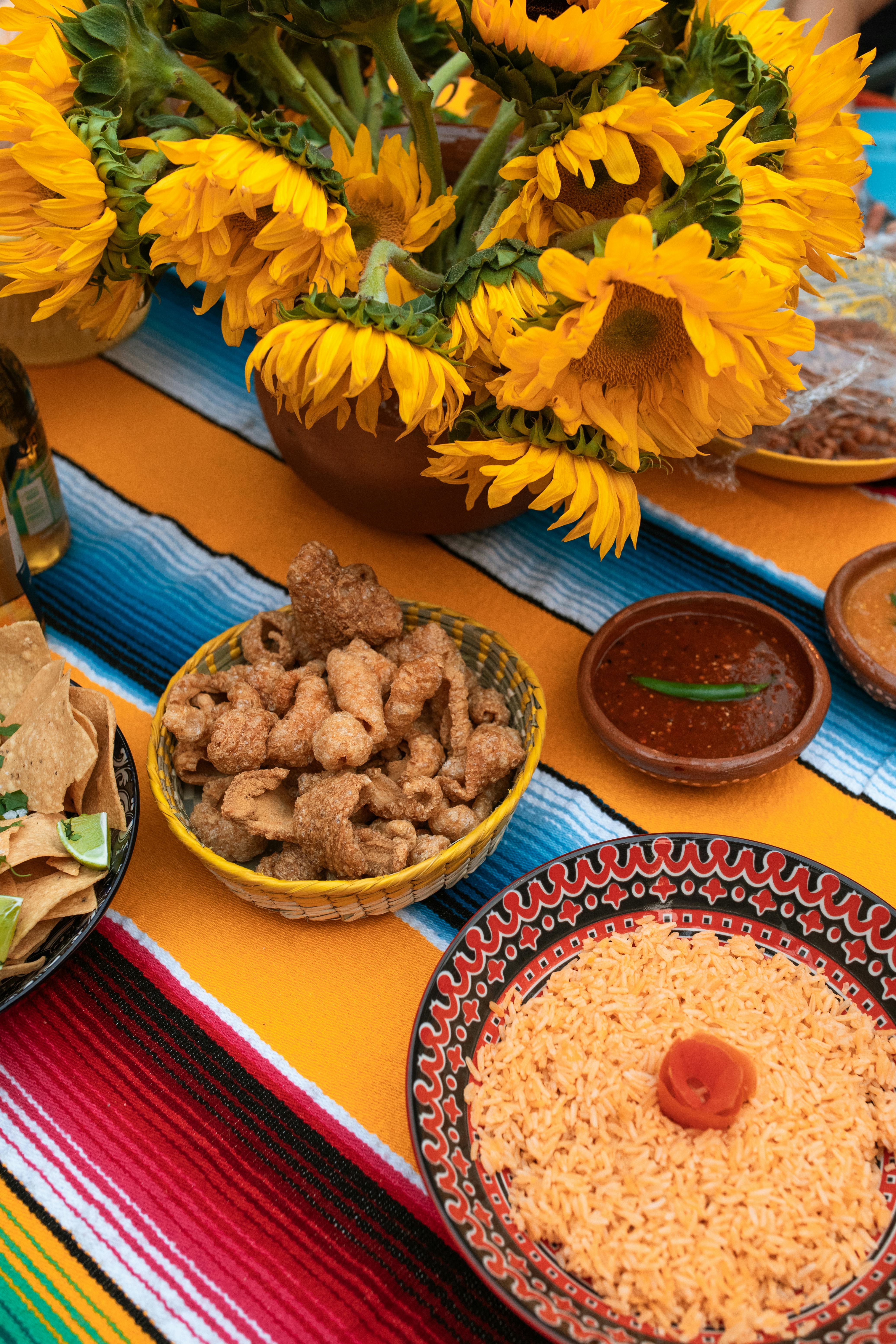 Mexican rice laid on a vibrantly striped cloth in a red bowl